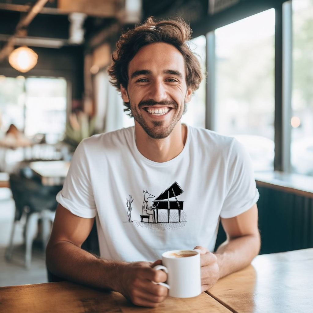 guy in a cafe drinking coffee wearing a white t-shirt with a fox playing piano print