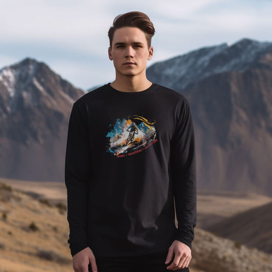 guy in the mountains wearing a black long sleeve t-shirt with a mountain bike print with the caption bikes + mountains = adventure