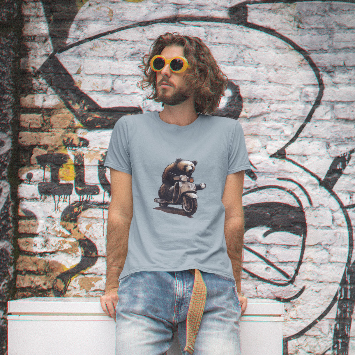 man wearing a light blue t-shirt with a bear riding a motor scooter