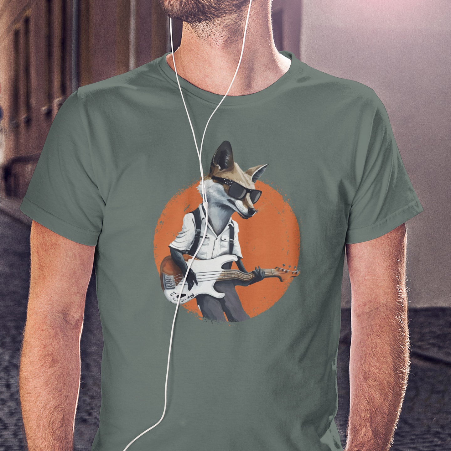 Guy wearing a green t-shirt with a print of a fox in sunglasses playing the bass guitar