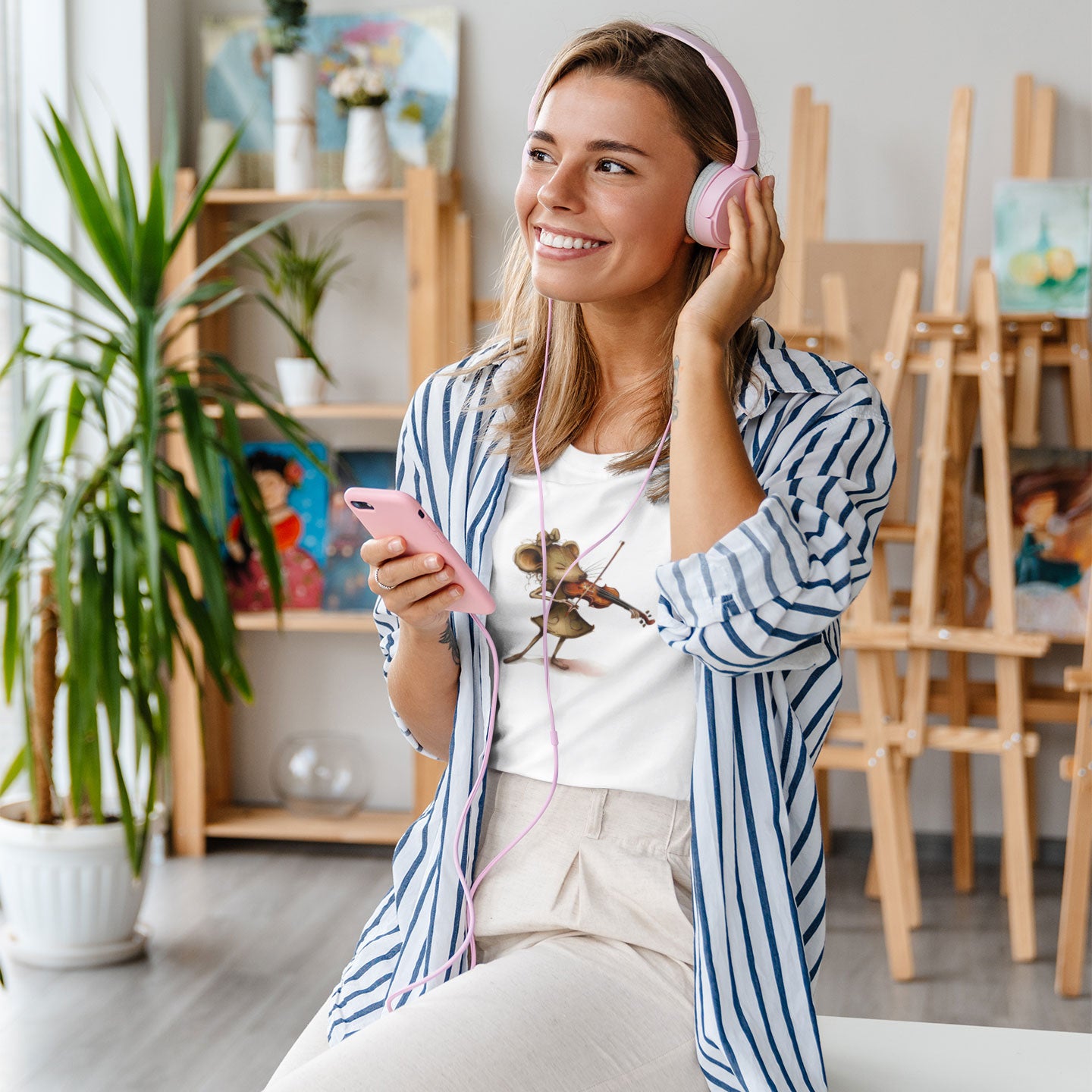 woman listening to music wearing a white t-shirt with a mouse playing a violin print
