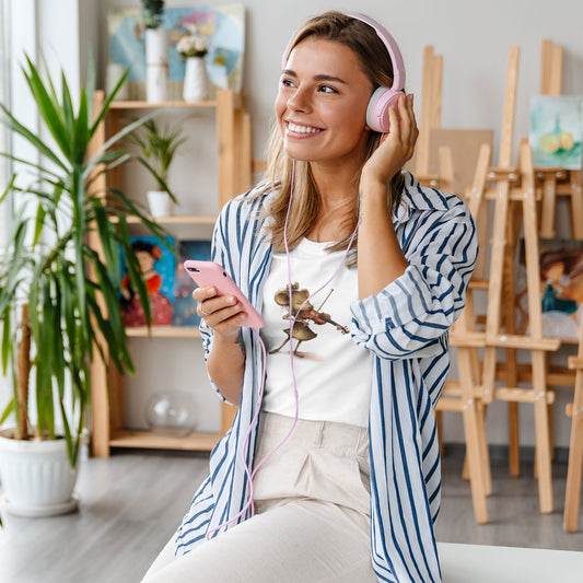 woman listening to music wearing a white t-shirt with a mouse playing a violin print