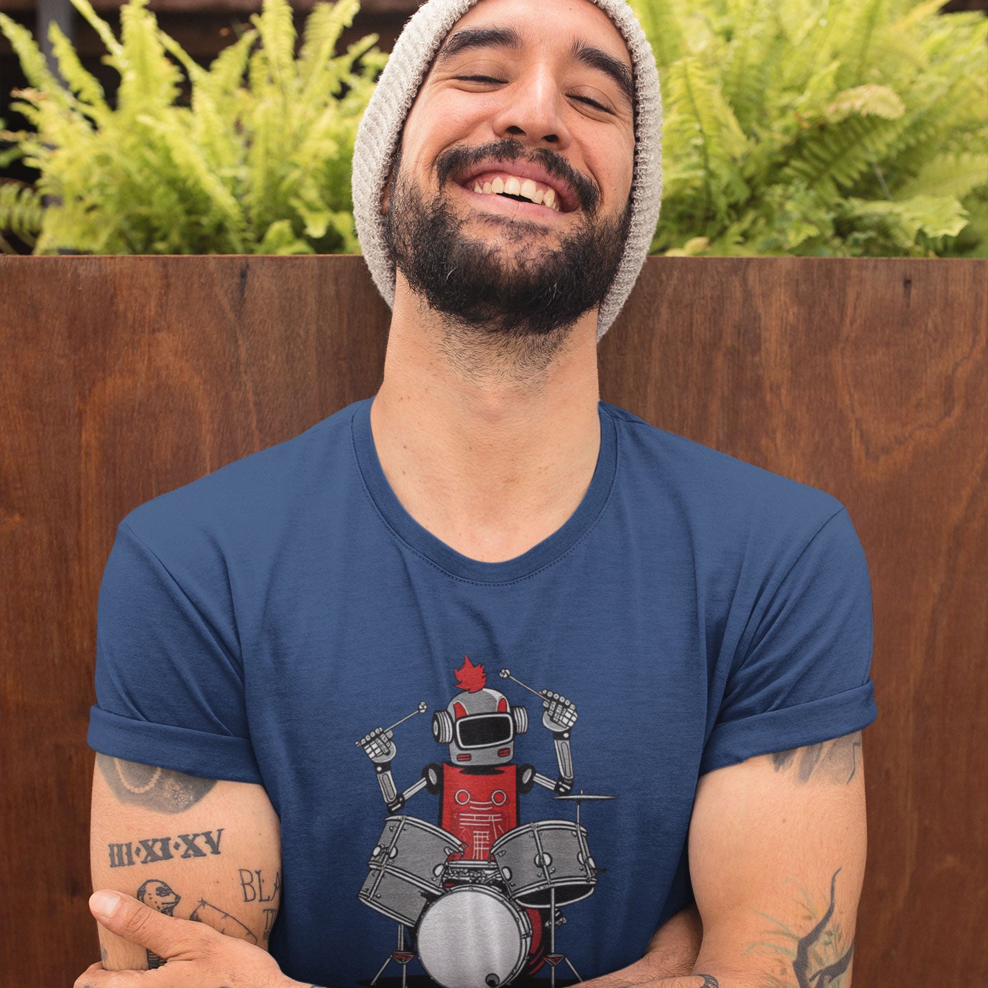 Guy wearing a blue t-shirt with a robot playing the drums graphic
