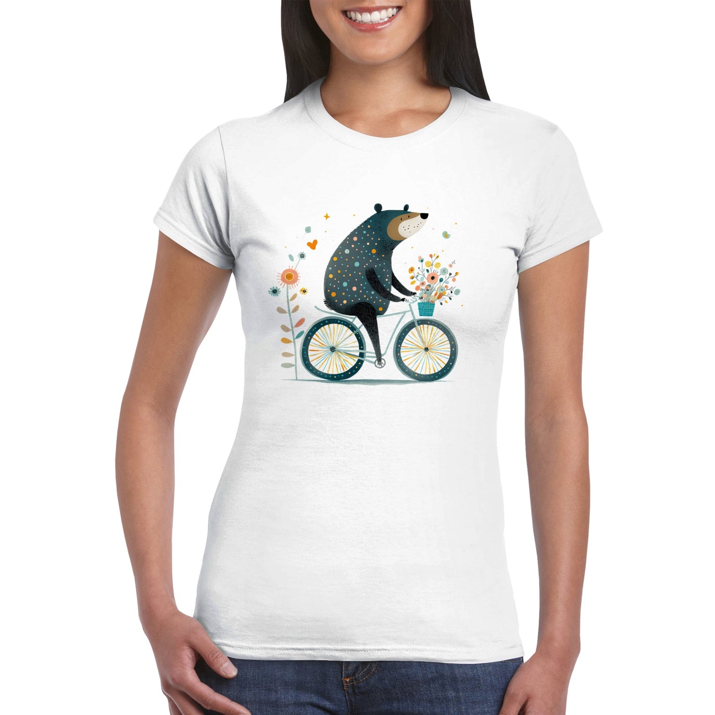 Woman wearing a white t-shirt with a cute bear riding a bicycle with a basket of flowers print