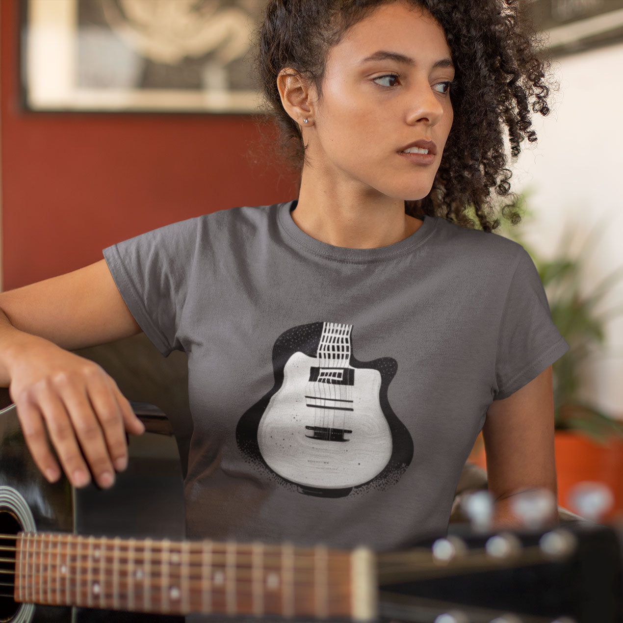 Woman wearing a grey t-shirt with Black and White Pop-Art Guitar Print
