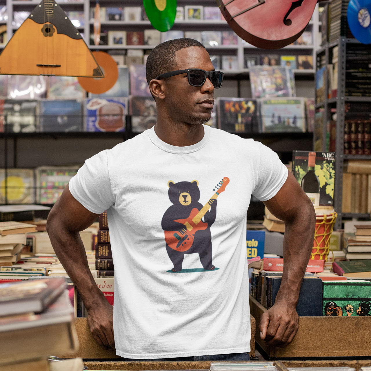 man waering a white t-shirt with a bear playing a guitar print