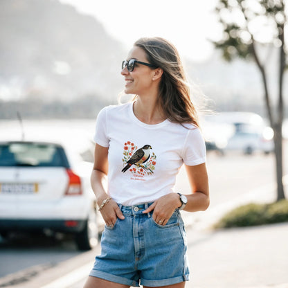 Woman wearing a white t-shirt with a Karearea NZ Falcon – 2025 Bird of the Year design outdoors