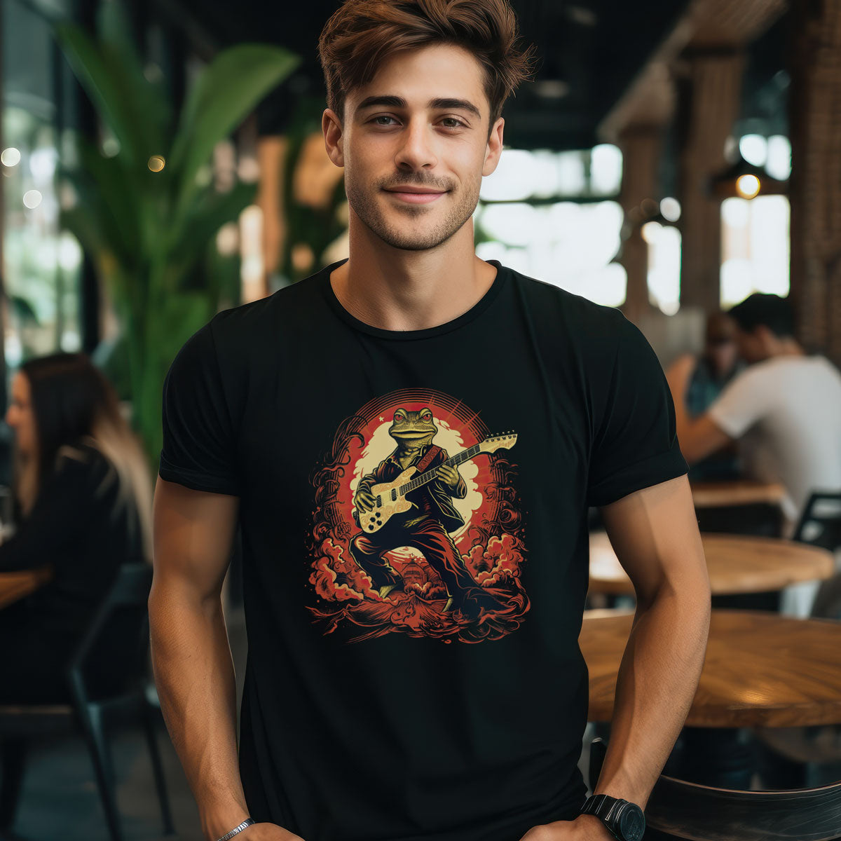 guy in a cafe wearing a black t-shirt with a frog playing the guitar print