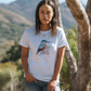 woman in the new zealand bush wearing a white t-shirt with a new zealand kingfisher kōtare print