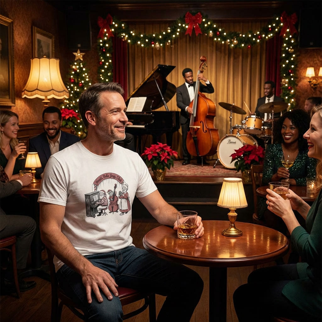 Man sitting at a table in a festive bar with a band playing in the background wearing t-shirt with Santa playing piano with elf on bass and Mrs Claus singing at the North Pole Jazz Club