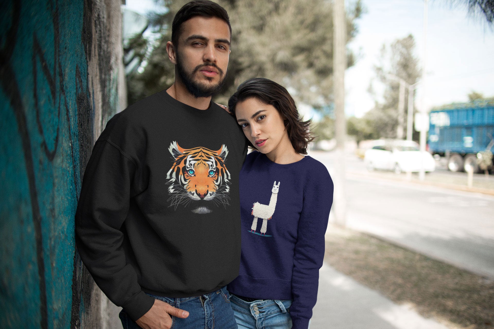 A couple wearing sweatshirts designed by The Purple Melon
