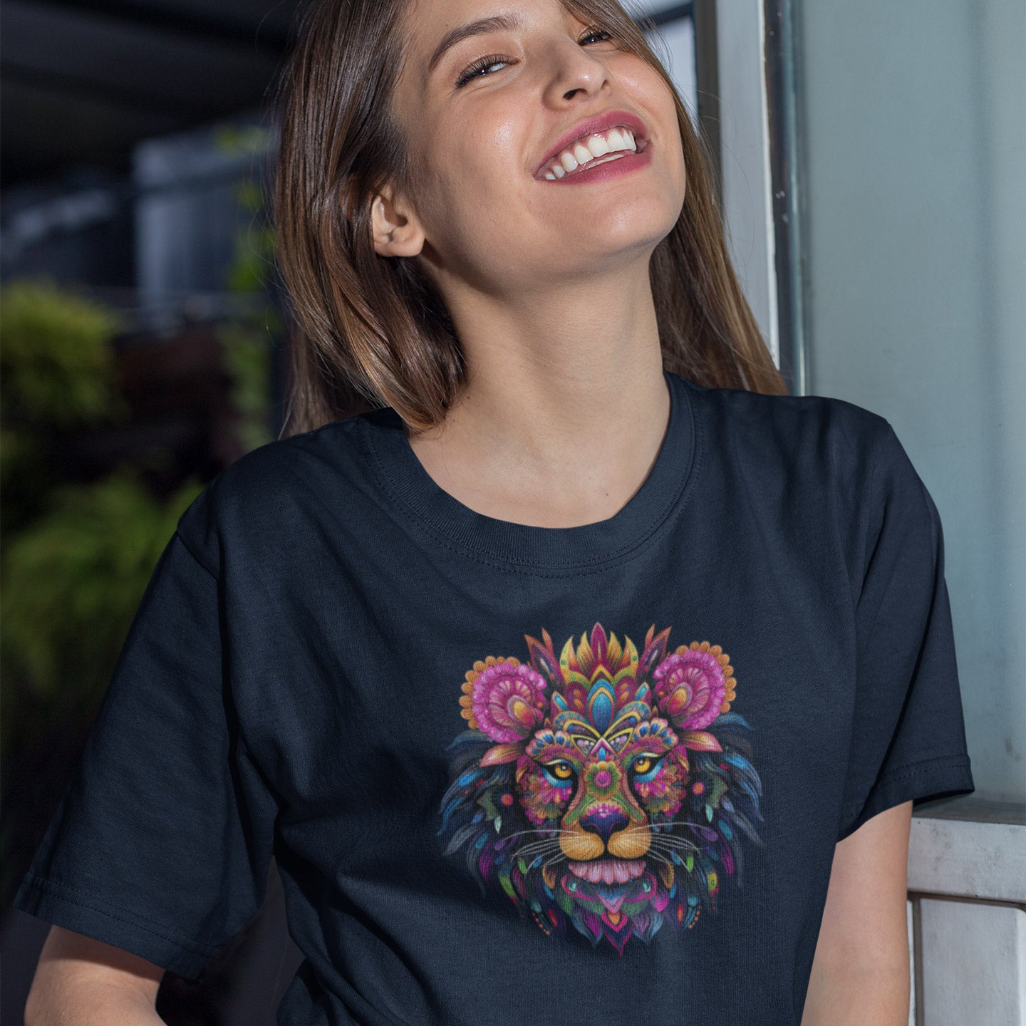 smiling woman wearing a navy blue t-shirt with a colorful floral lion print