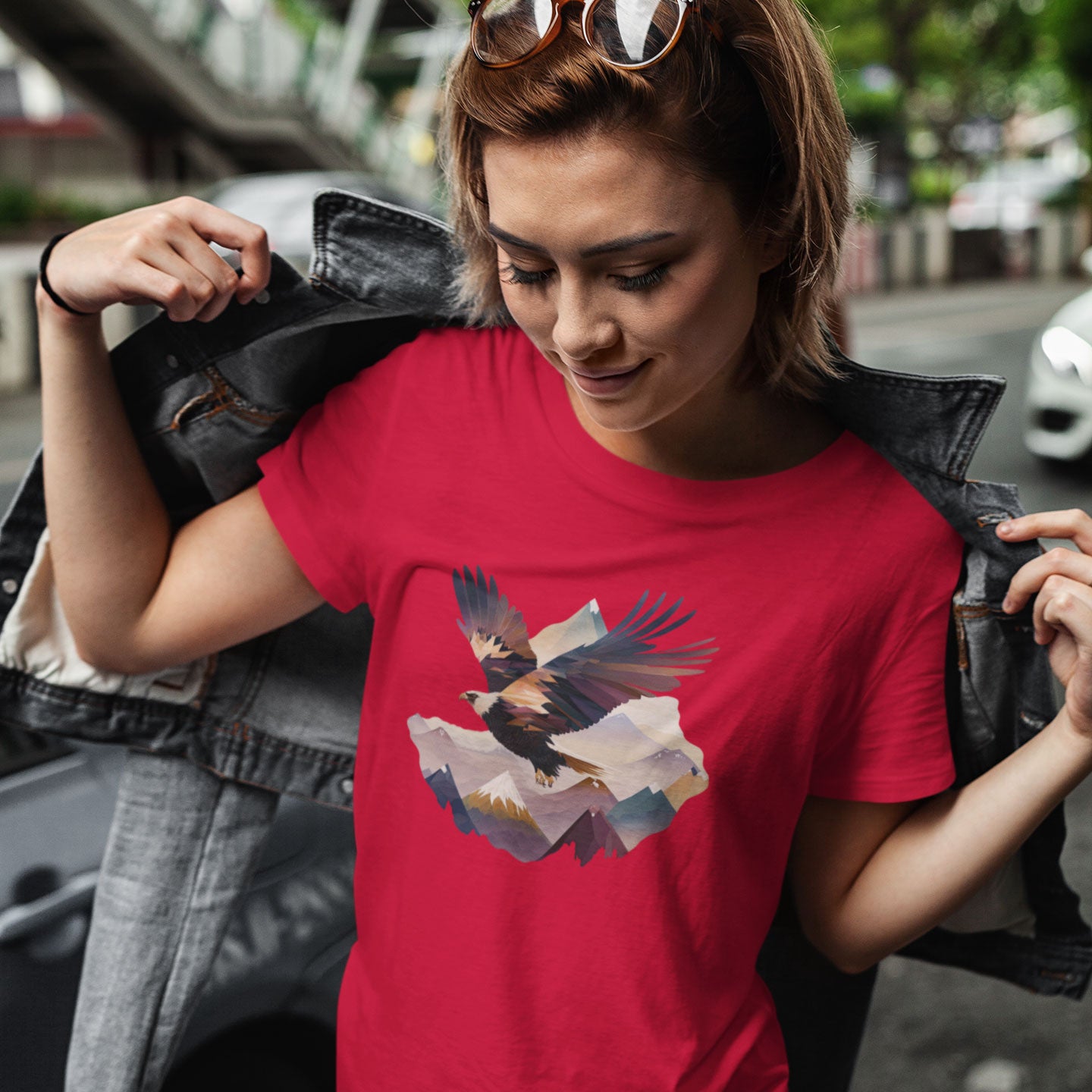 woman wearing a red t-shirt with an eagle flying over a mountain range print