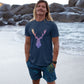 guy on the beach wearing a navy blue t-shirt with a rainbow moose print