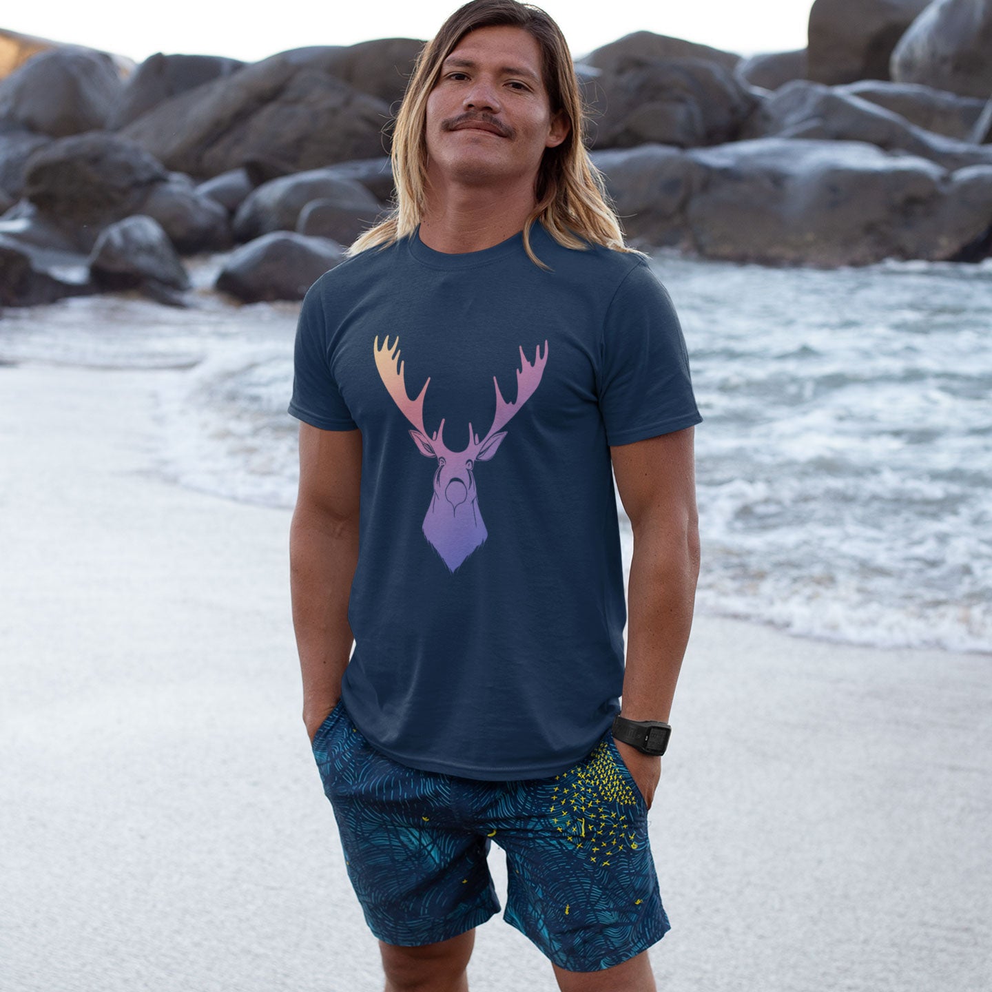 guy on the beach wearing a navy blue t-shirt with a rainbow moose print