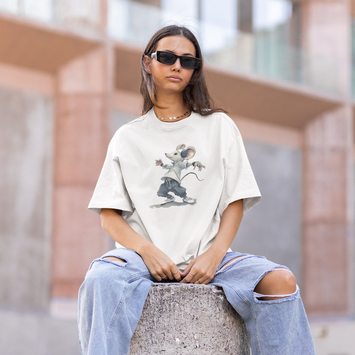 Girl sitting post wearing a white t-shirt with a hip hop mouse print