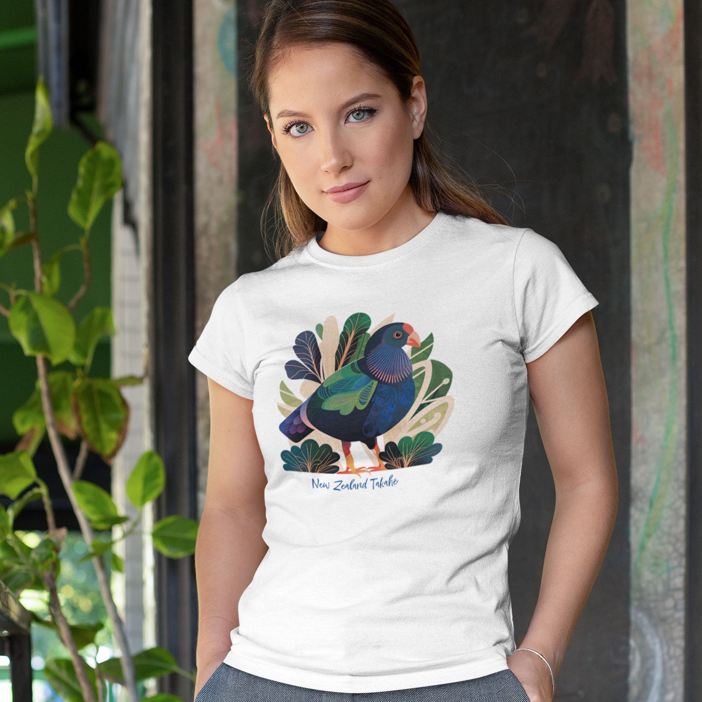A woman wearing a white t-shirt with a new zealand takahe print