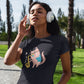 Woman listening to music wearing a black t-shirt with a pink cat playing the saxophone print