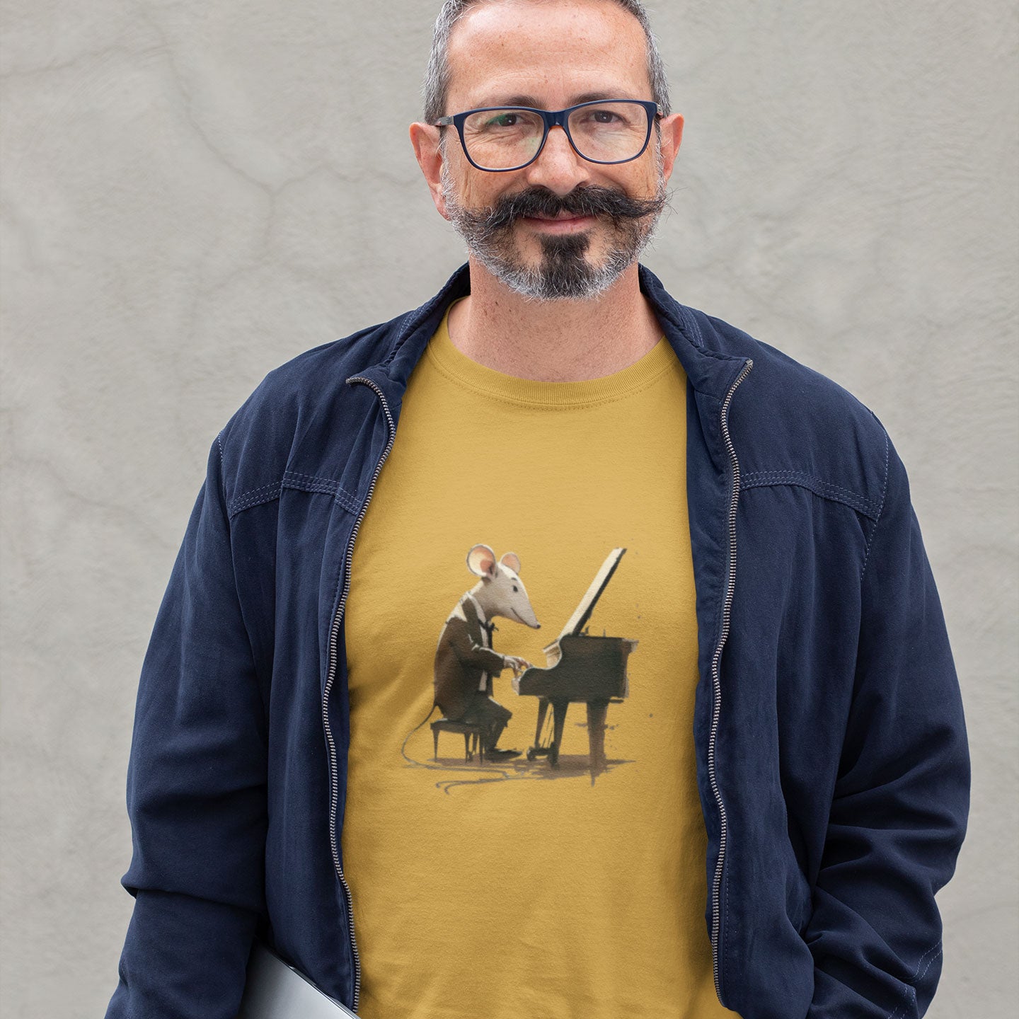 A guy wearing a gold t-shirt with a mouse playing a piano print