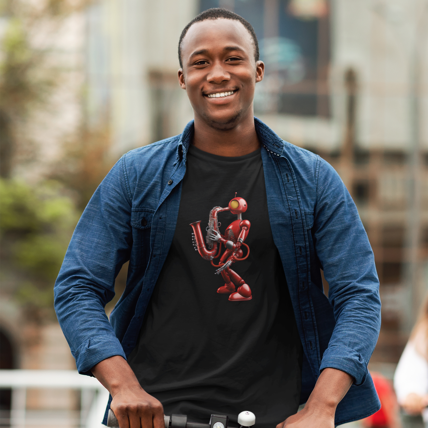 A guy wearing a black t-shirt with a red robot playing a saxophone