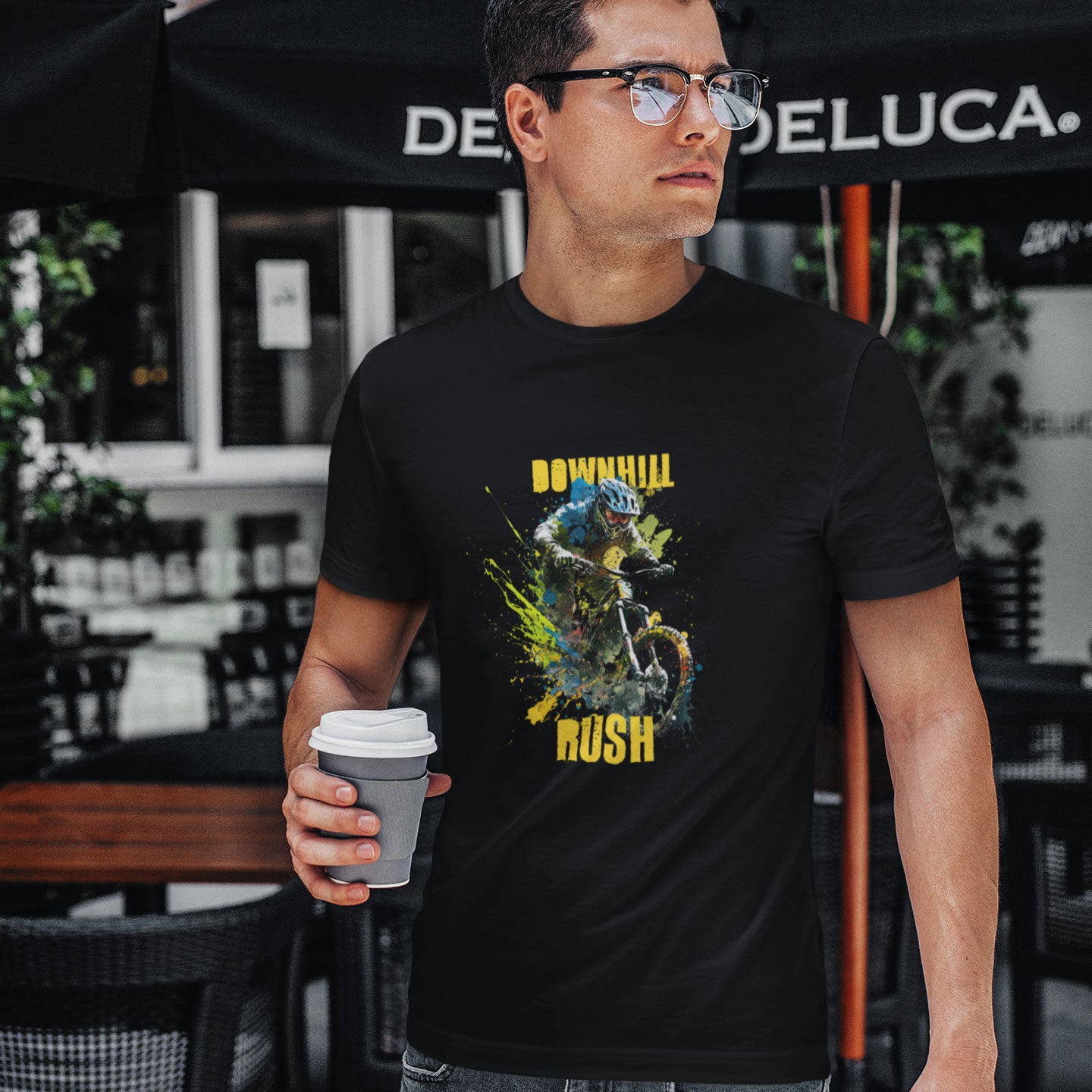 Guy drinking coffee wearing a black t-shirt with a downhill mountain biker print and the caption Downhill Rush