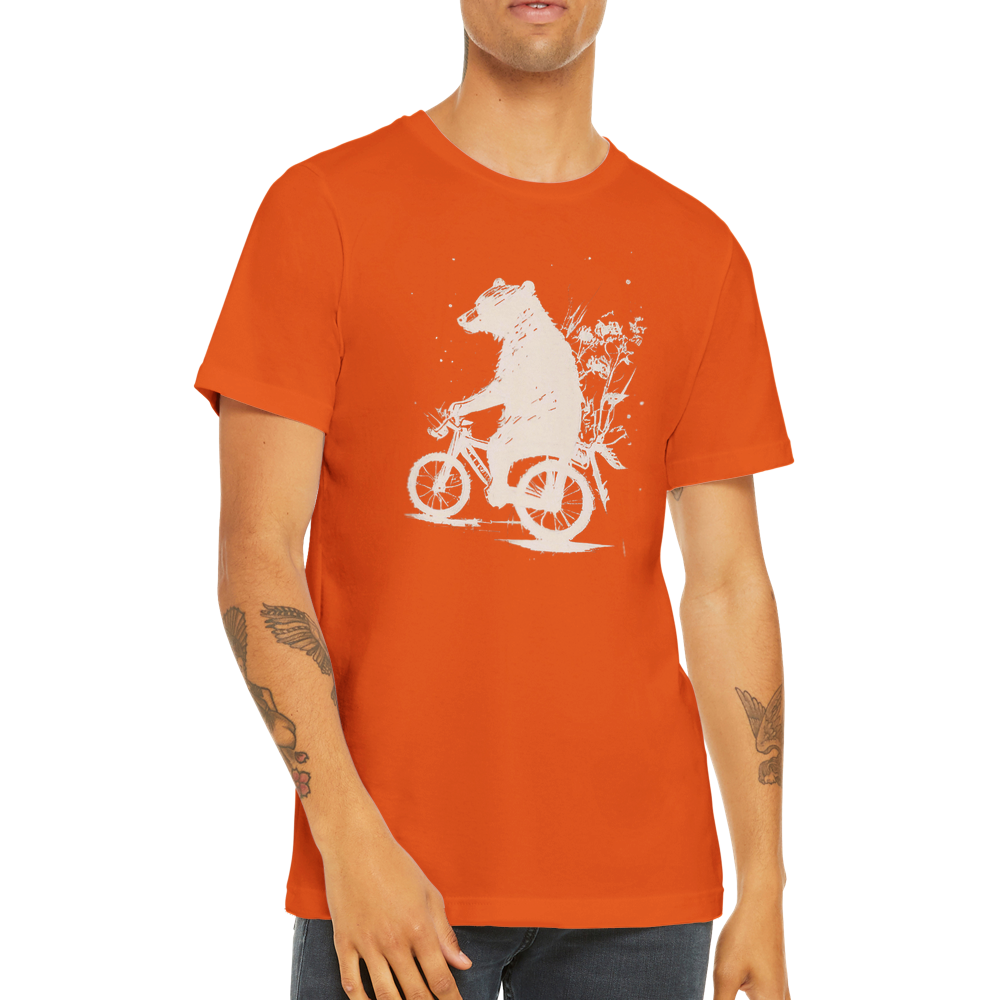 A guy wearing a orange t-shirt with a bear riding a bike print