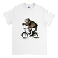 White t-shirt with a bear in shorts and cap riding a bike