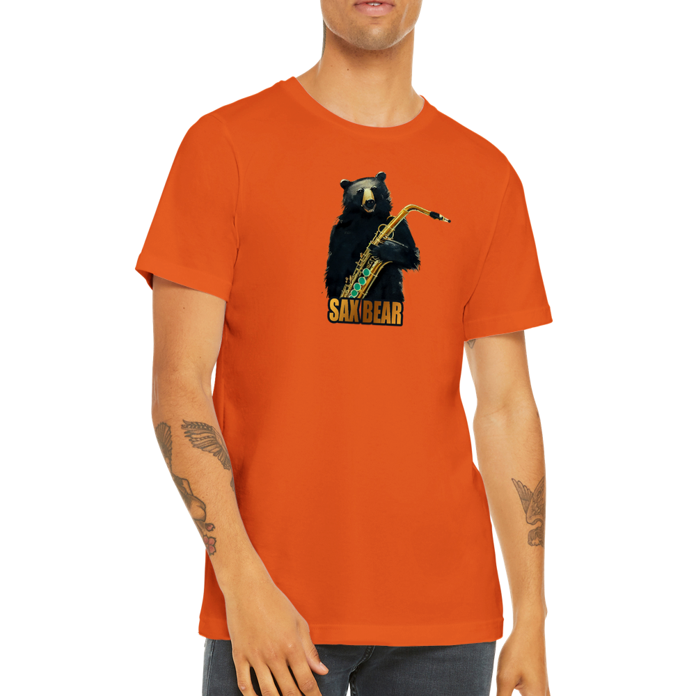 Guy wearing an orange t-shirt with a print of a bear holding a saxophone with the caption Sax Bear