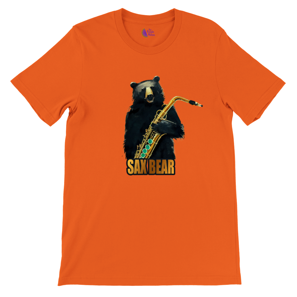 An orange t-shirt with a print of a bear holding a saxophone with the caption Sax Bear