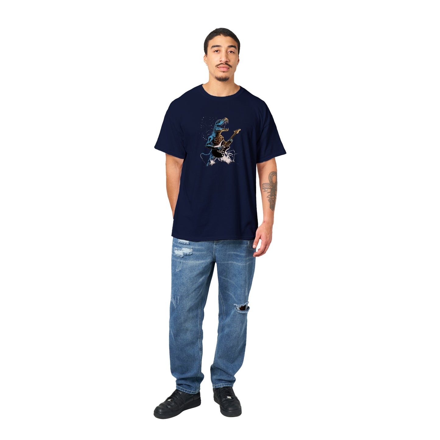 A guy wearing a navy t-shirt with a t-rex shredding out on a guitar print