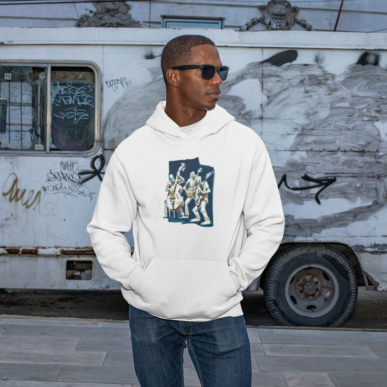 A man wearing a white hoodie with a Jazz trio print on the front