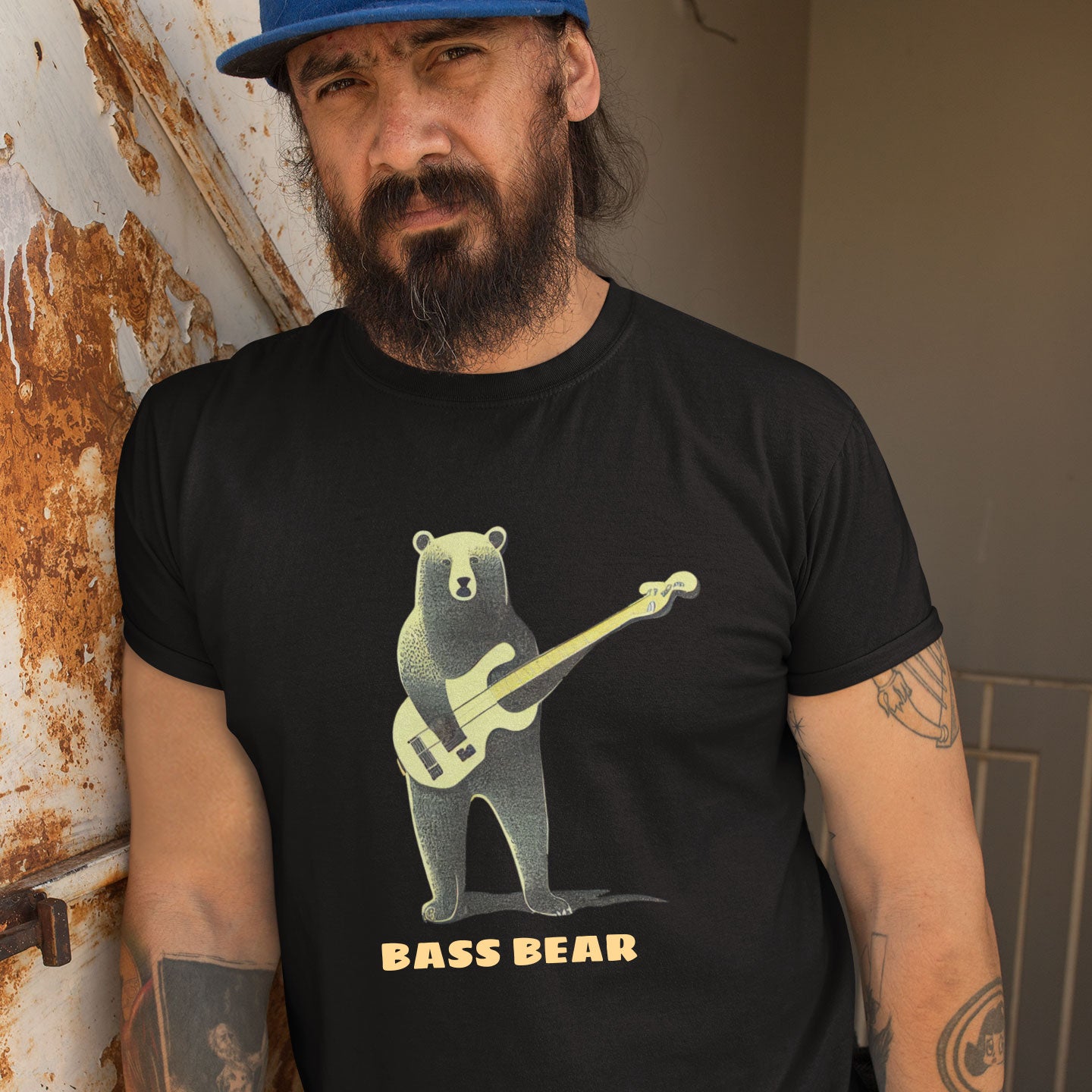 Man wearing a black t-shirt with a bear playing the bass guitar print