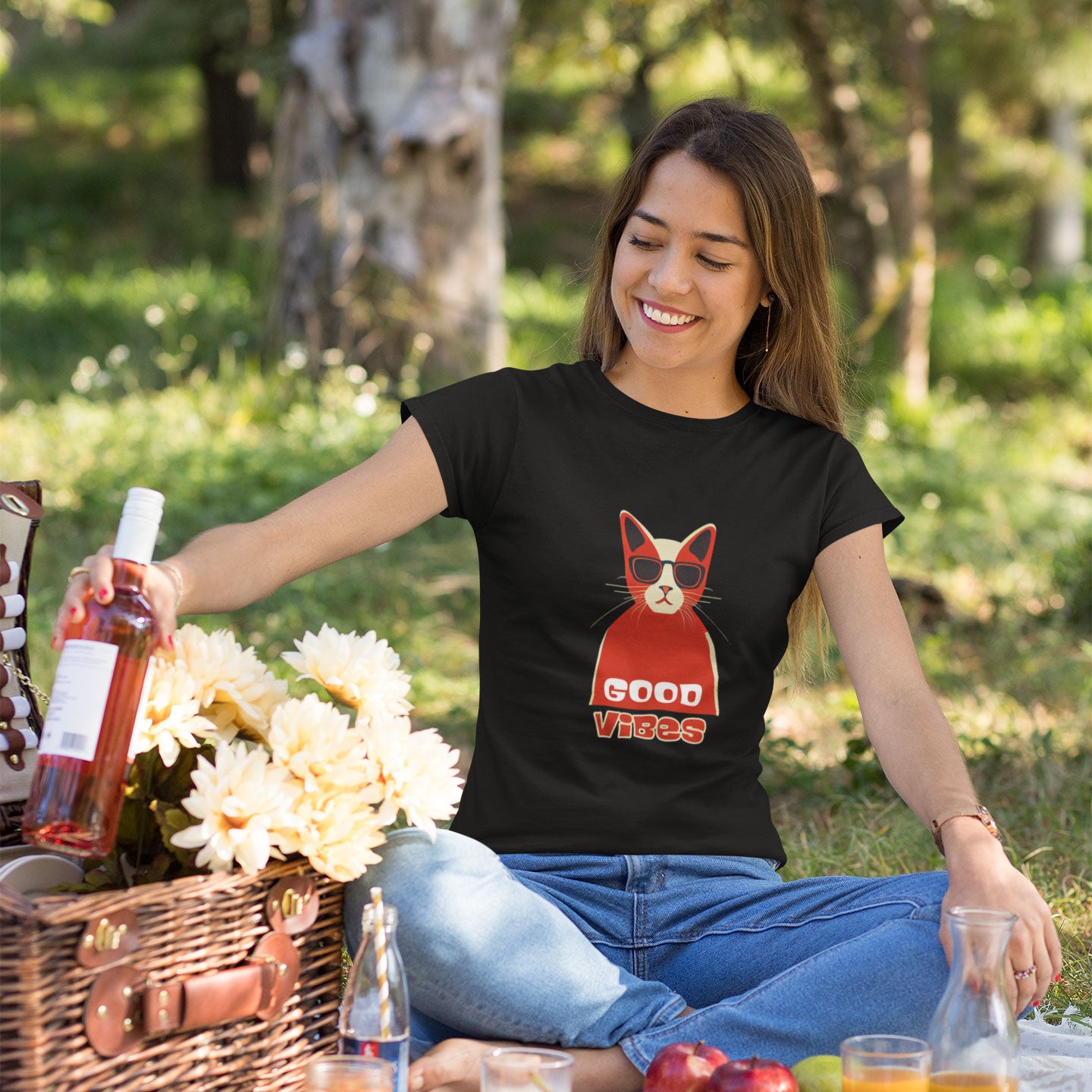 Woman having a picnic wearing a black t-shirt with a cool good vibes cat print